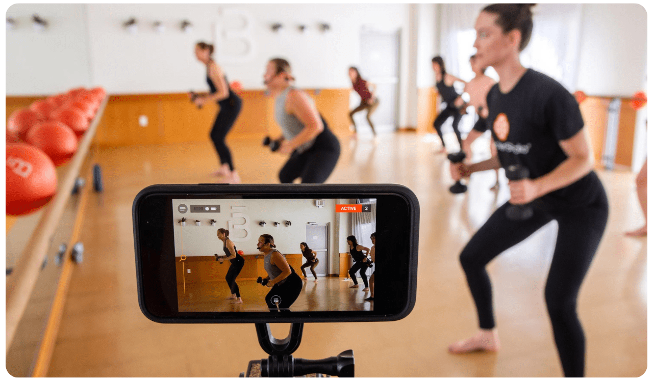 image of phone streaming a fitness class in a sunny studio